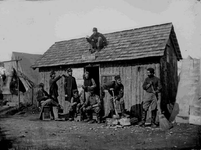 Soldiers in Front of a Wooden Hut